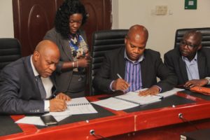Dr Oluwafemi Babalola (L) and Mr Lateef Kaffo (R) Directors of 1XBET signing the Terms and Conditions